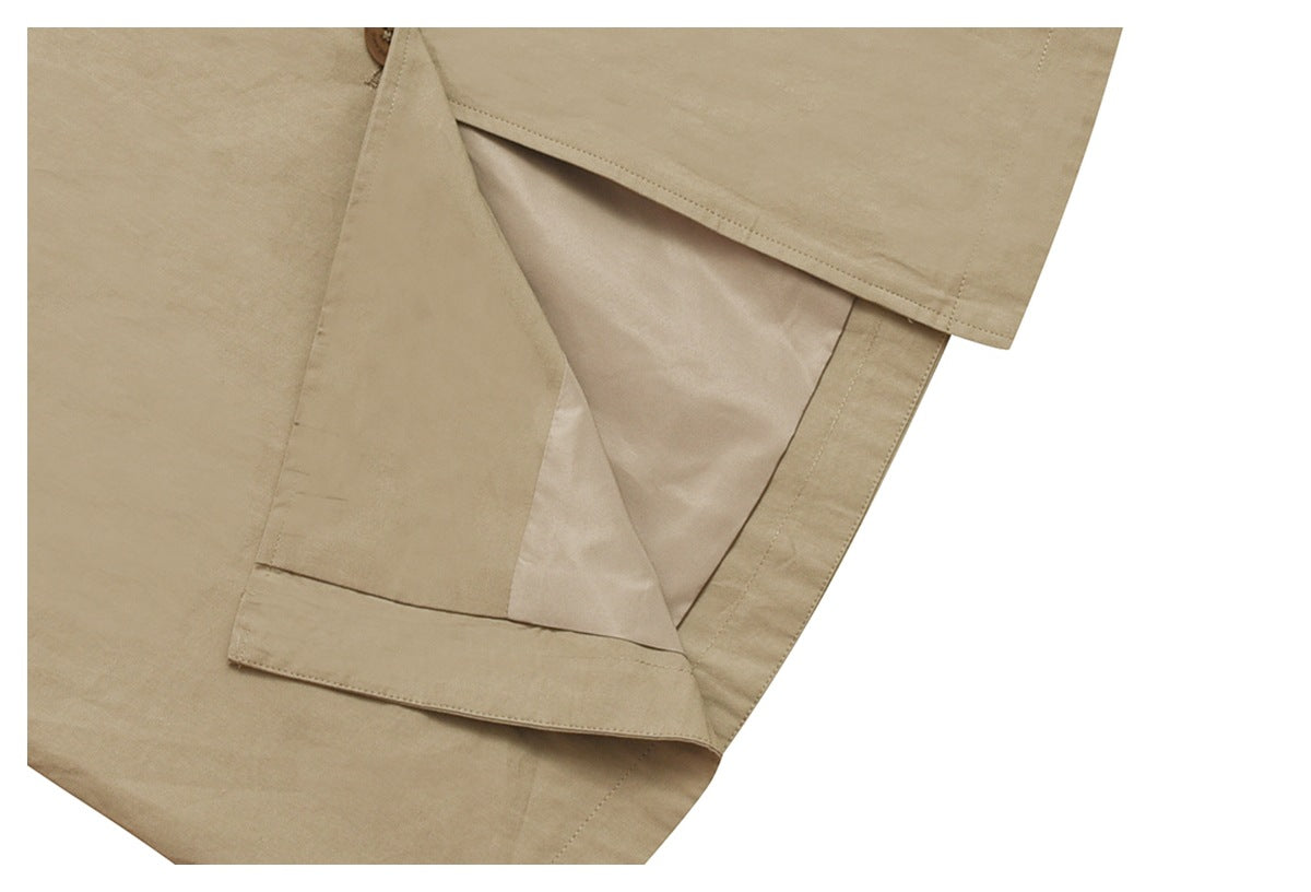 Close-up of a beige garment opening, showing its pale lining, stitched edges and a small button.