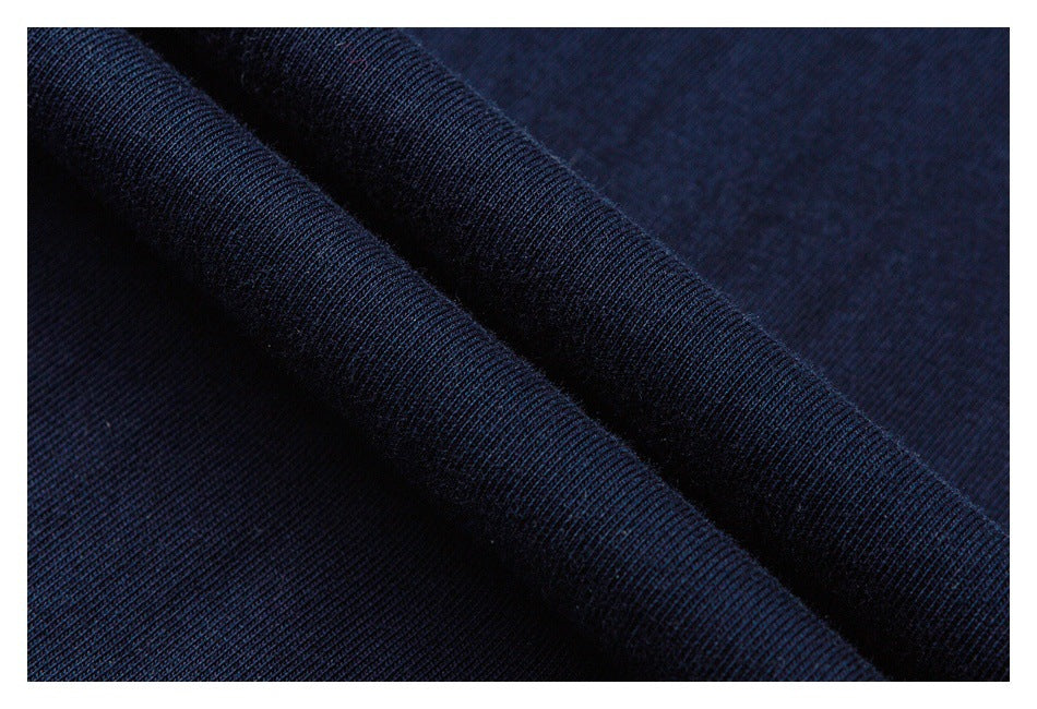 Close-up of dark navy knit fabric draped in soft folds.