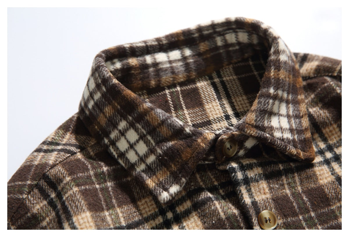 Close-up of the brown and cream plaid shirt's pointed collar and top front button.