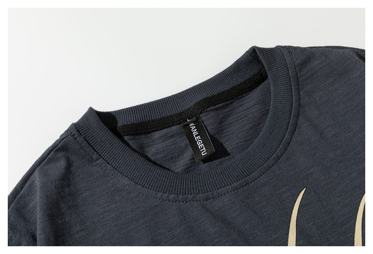 Close-up of the charcoal T-shirt's ribbed crew neck and black sewn-in label.