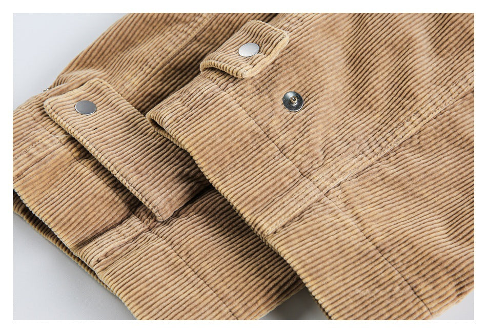 Close-up of overlapping tan corduroy panels with snap fasteners and stitched tabs.