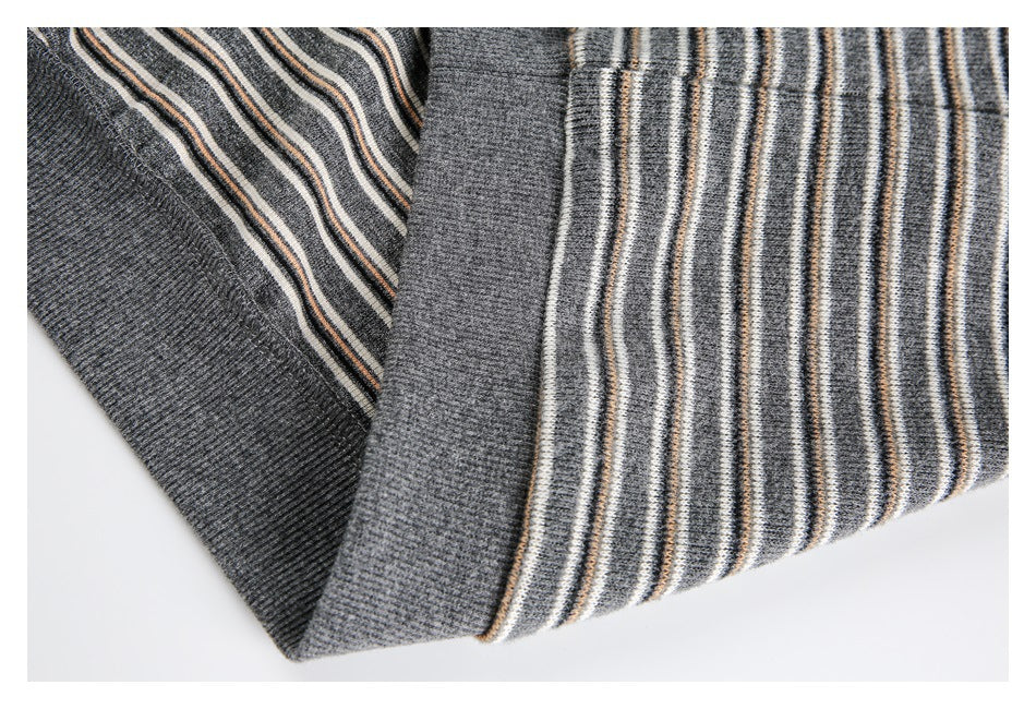 Close-up of striped knit sleeves with solid gray ribbed cuffs.