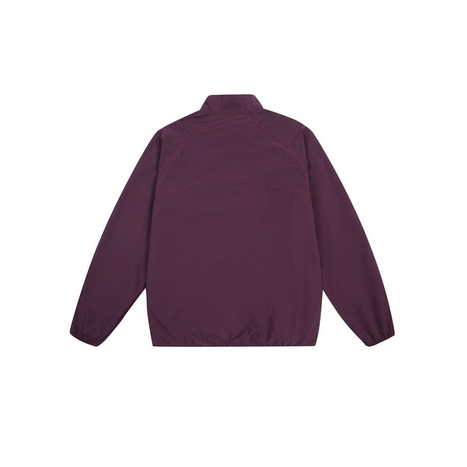 Back view of a deep plum long-sleeve jacket with a stand collar, curved seams and elastic cuffs and hem.
