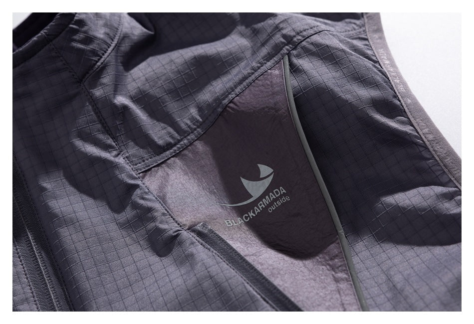 Close-up of a charcoal jacket panel with a small BLACKARMADA outside logo.