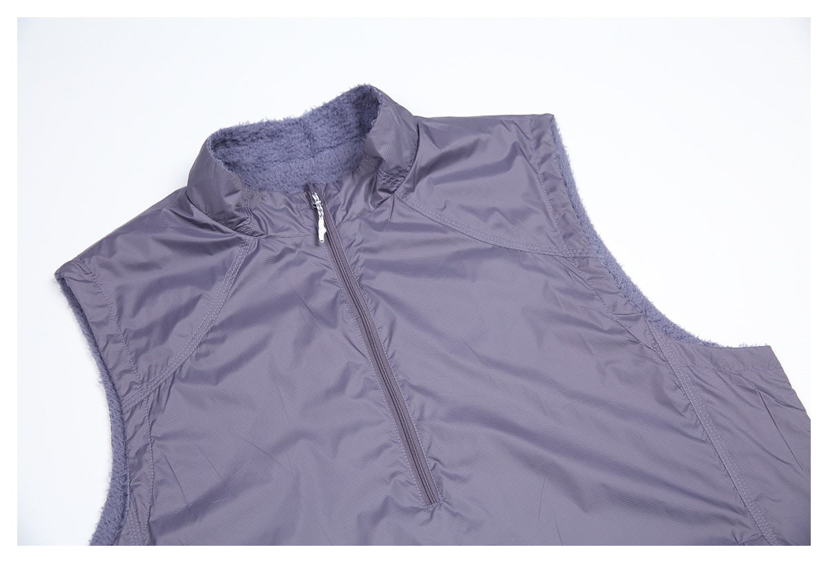 Close-up of the vest's stand collar, front zipper, and contrasting smooth panels over fuzzy lining.