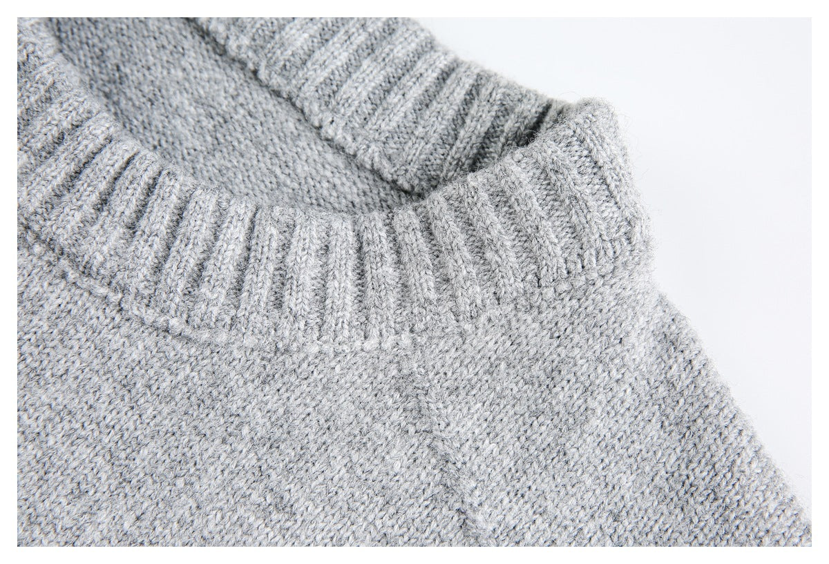 Close-up of the light gray sweater's thick ribbed neckline and knit texture.