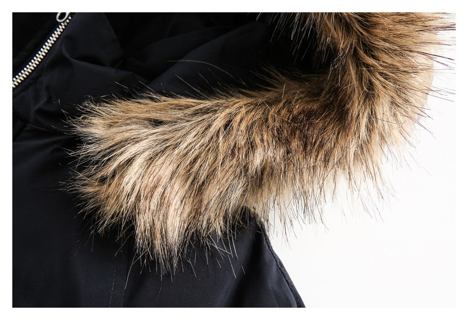 Close-up of brown and tan fur trim along the hood of a black coat.