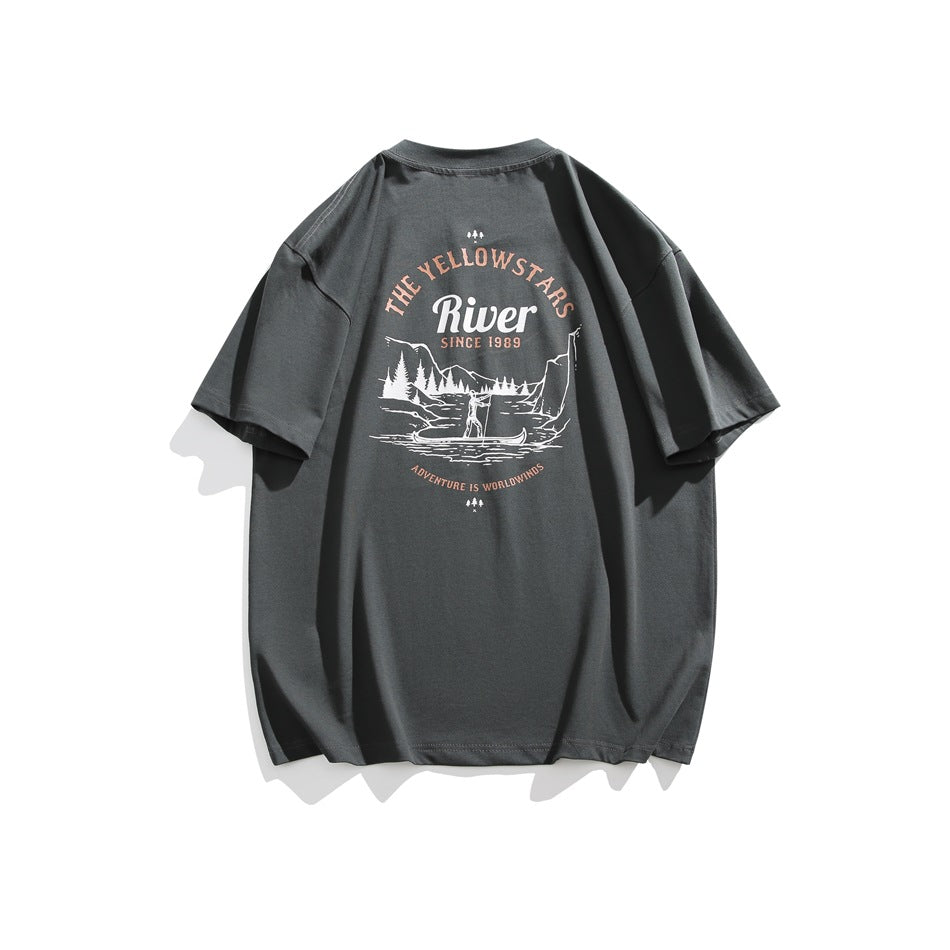 Back of a charcoal gray T-shirt with a vintage Yellowstone River landscape graphic in cream and muted peach.