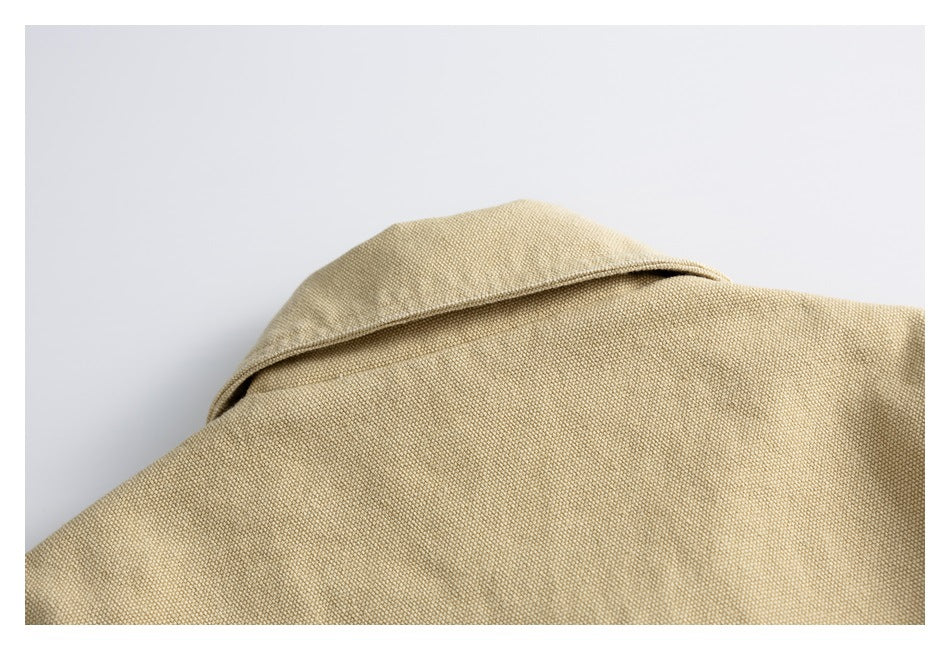 Close-up of the tan jacket's wide folded collar and upper shoulder.