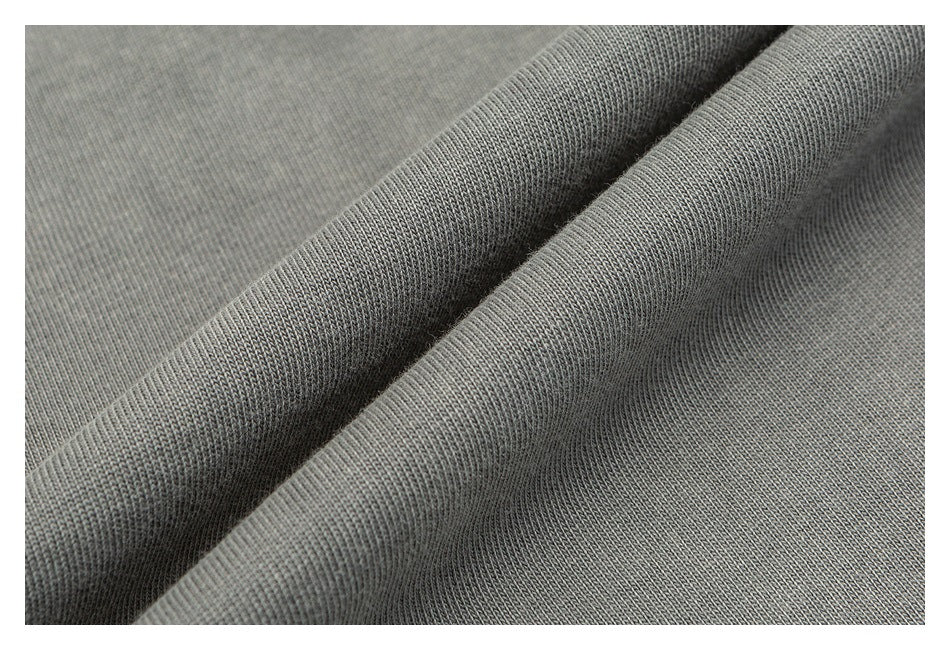 Close-up of folded gray knit fabric showing its fine texture.