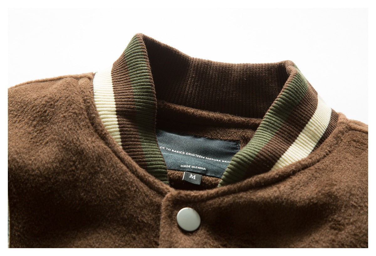 Close-up of a brown fuzzy jacket collar with striped ribbing, a snap button, and a visible neck label.