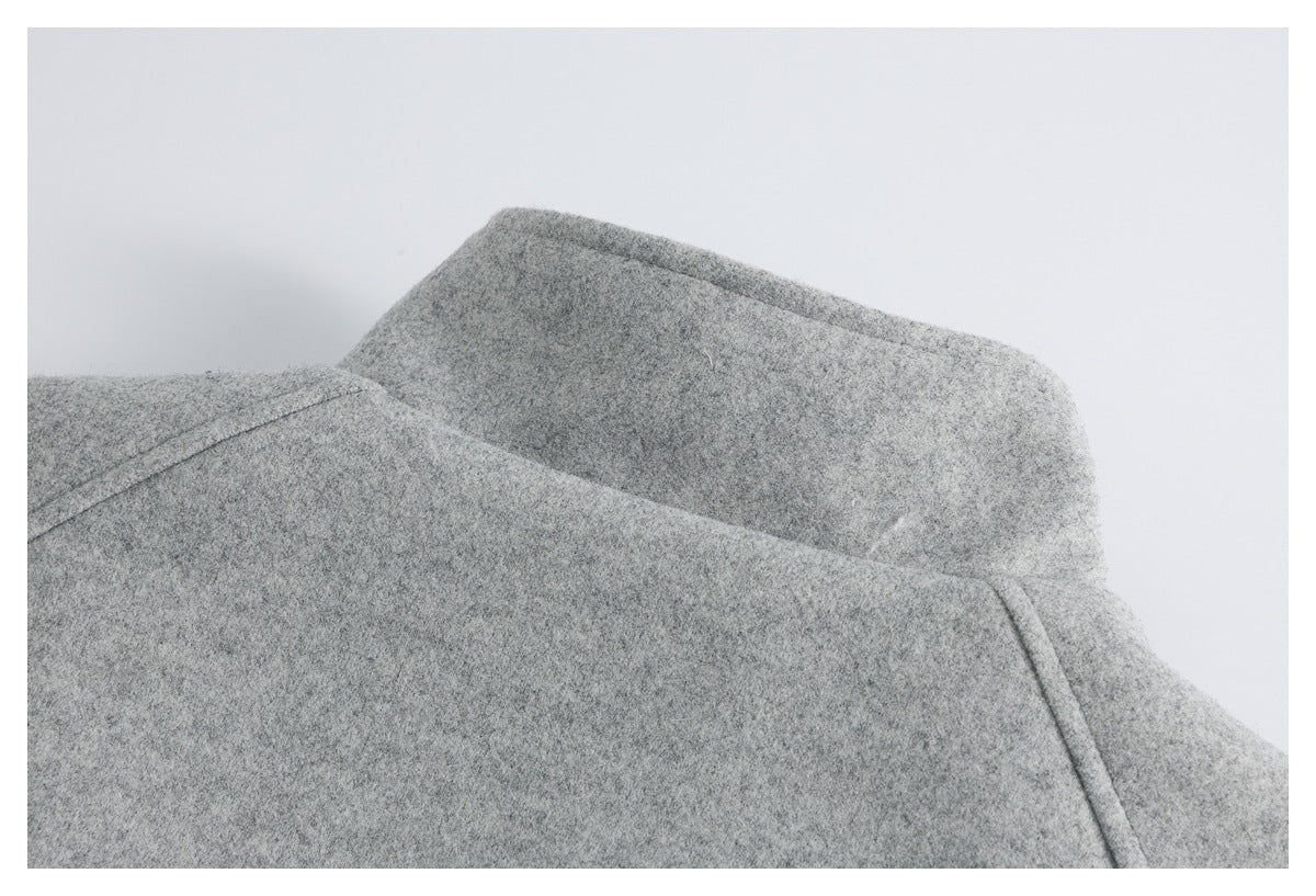 Close-up of the gray jacket's folded collar and upper shoulder seam.