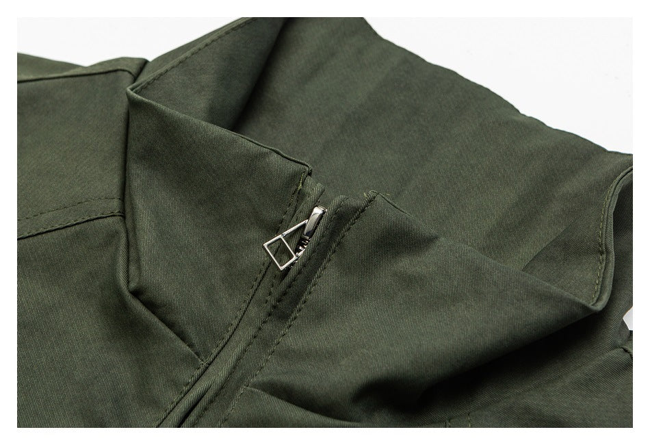Close-up of a dark olive garment collar and silver zipper pull.