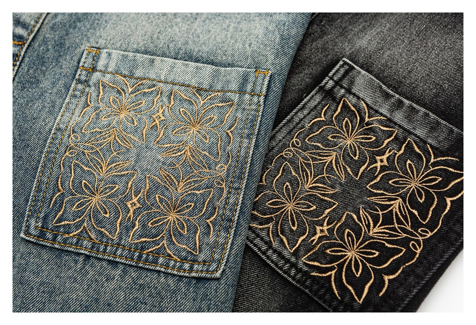 Blue and black denim back pockets with matching intricate gold floral embroidery.