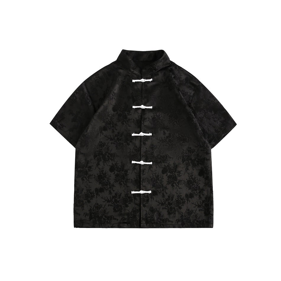 Black short-sleeve stand-collar shirt with tonal floral jacquard and five white knot buttons, flat lay front view