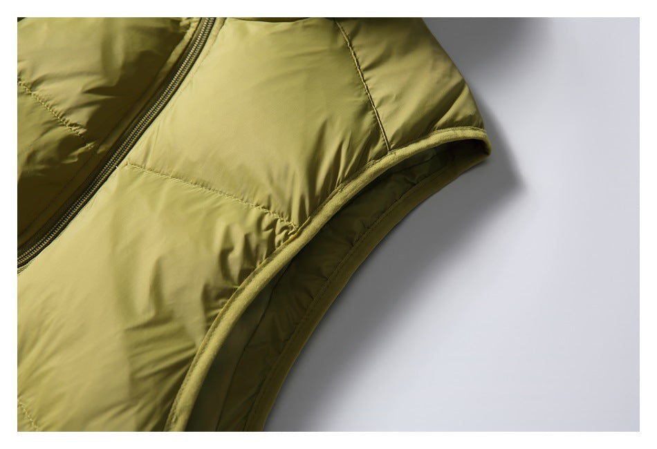 Close-up of the olive-yellow jacket's side seam and bound armhole edge.