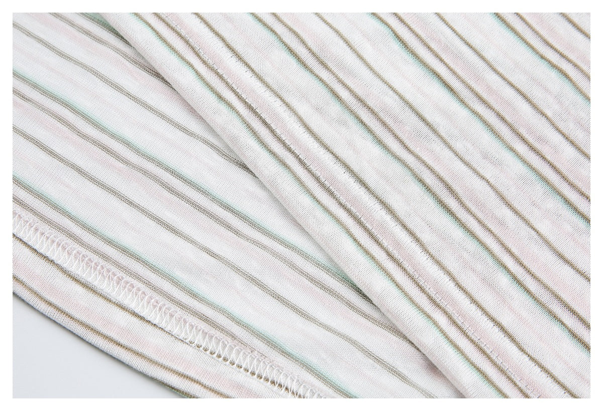 Close-up of striped off-white knit showing a folded seam with white overlock stitching.