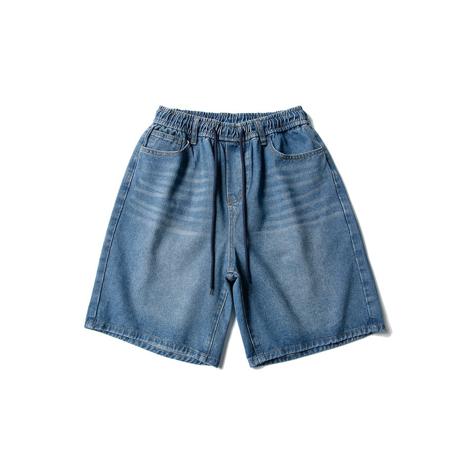 Front view of blue washed denim shorts with elastic drawstring waistband and front pockets