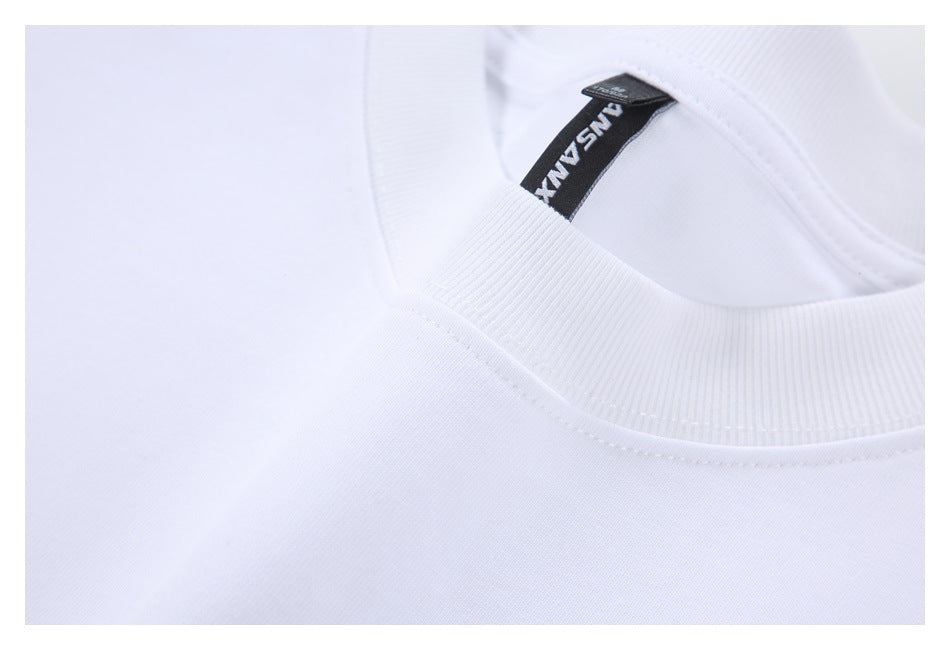 Close-up of the white T-shirt's ribbed crew neckline, stitching, and black inner neck label.