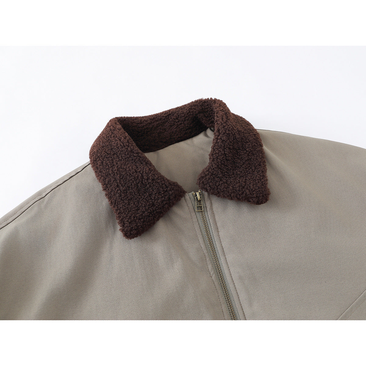 Close-up of a taupe jacket with a dark brown textured collar and metal front zipper.