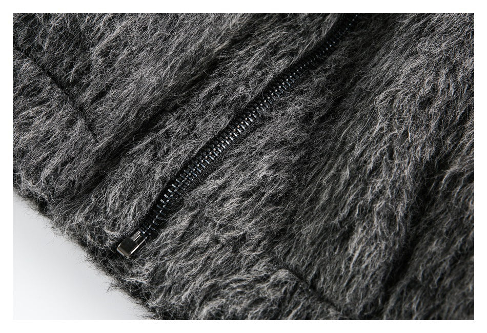 Close-up of a black zipper set into shaggy charcoal-gray fabric.