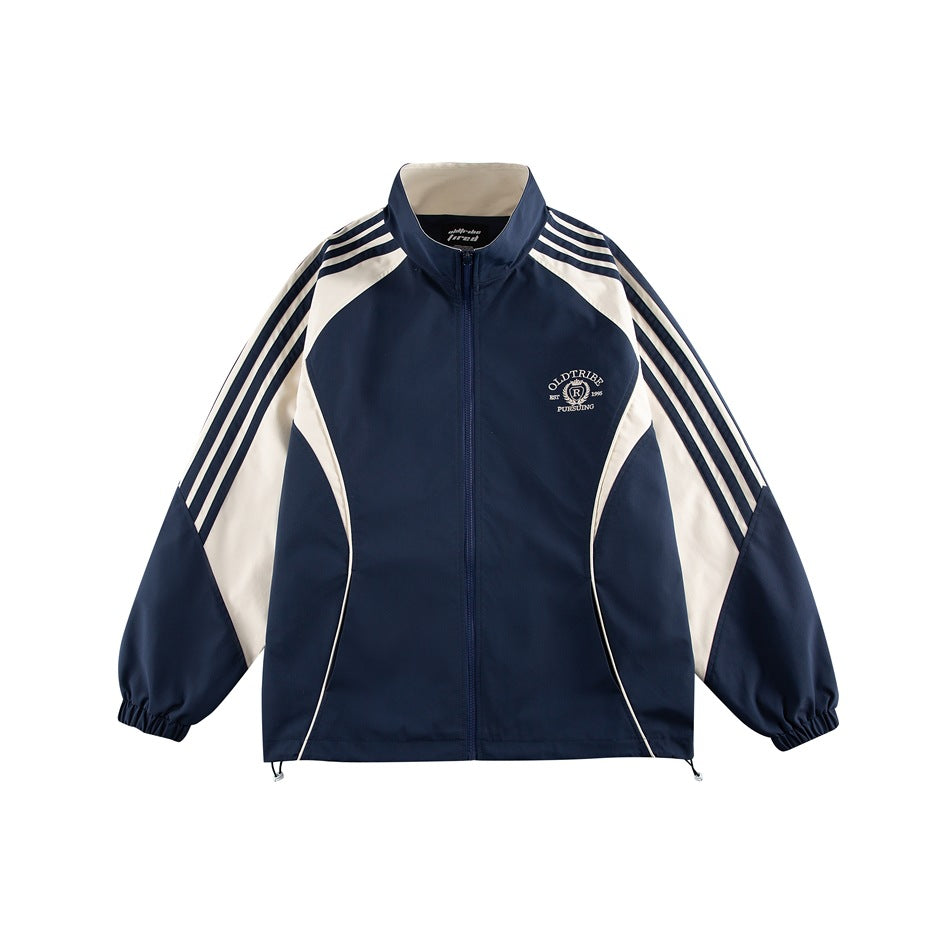 Navy and cream color-block zip jacket with stand collar, striped raglan sleeves and embroidered chest emblem, front view