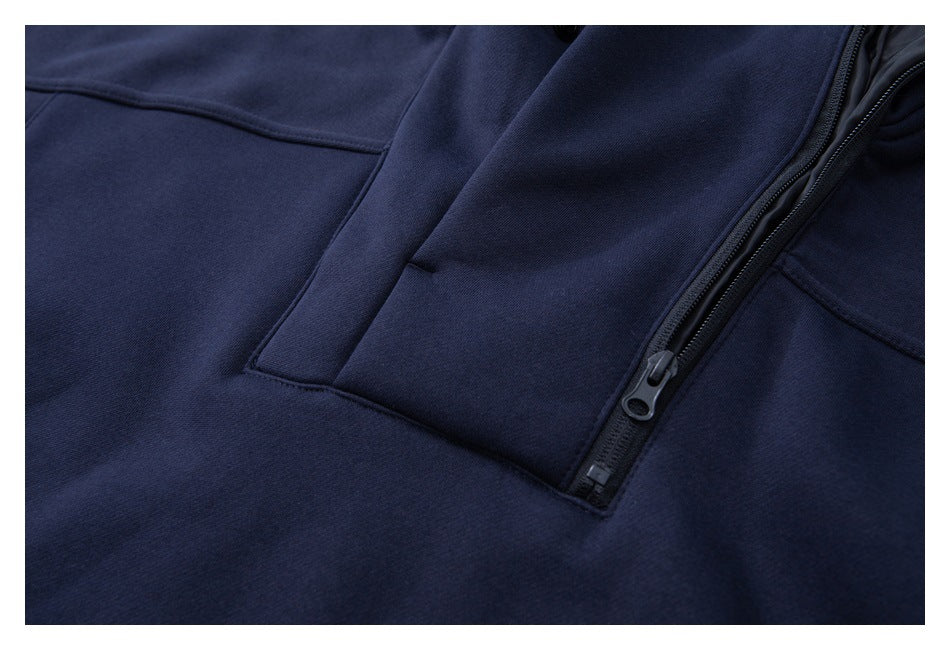 Close-up of the navy pullover's front zipper, placket, and stitching.