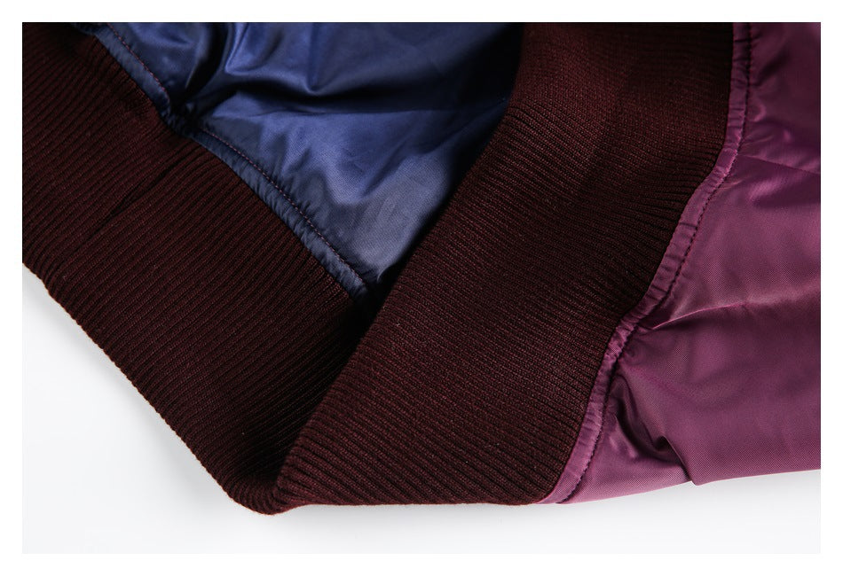 Close-up of the plum jacket's dark burgundy ribbed hem and blue lining.