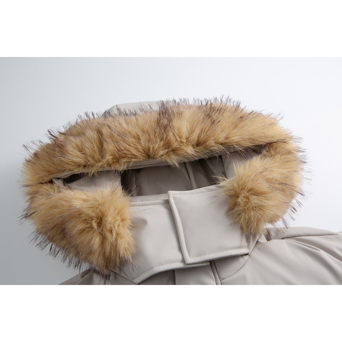 Close-up of a light gray jacket hood with thick tan faux-fur trim and a glimpse of the lining.