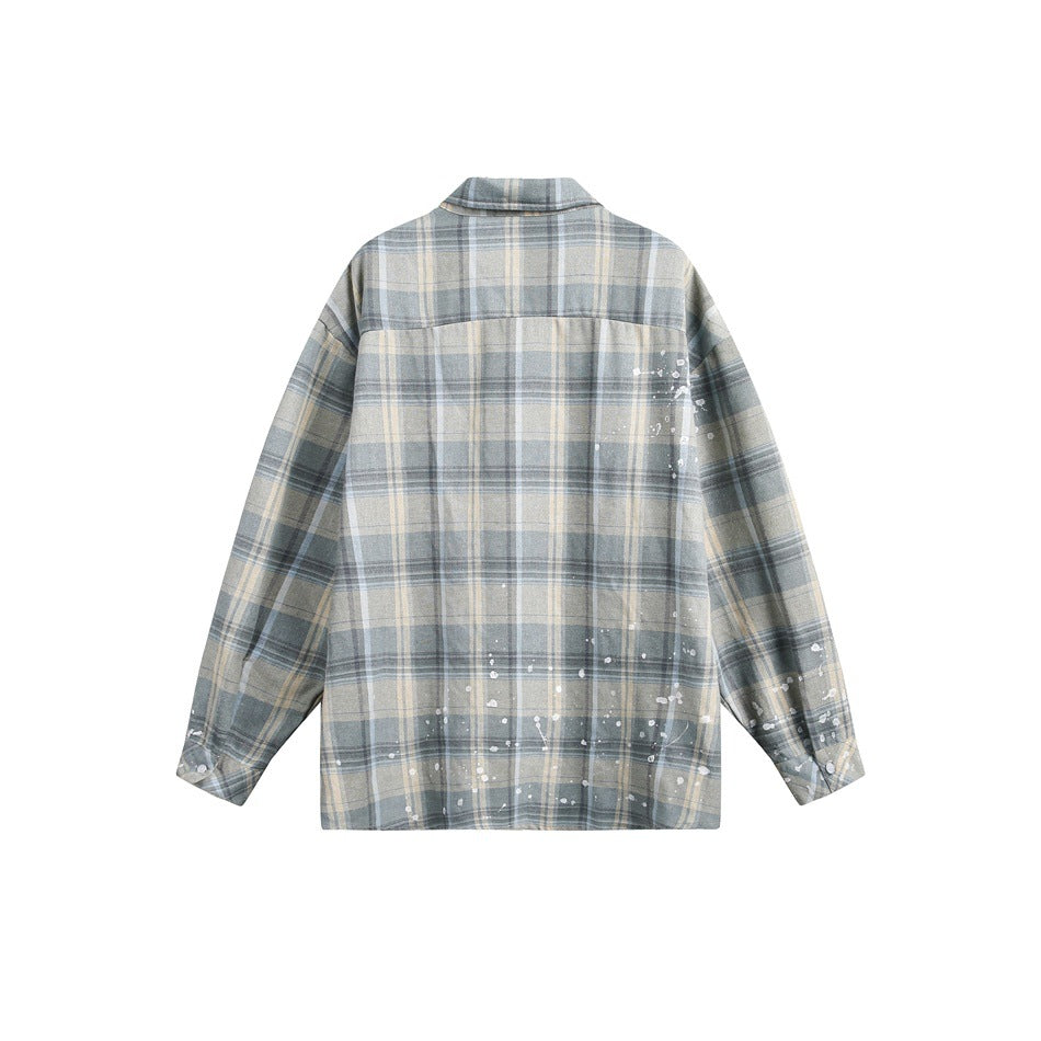 Back of a gray-blue and cream plaid button-up shirt with white paint-splatter accents.