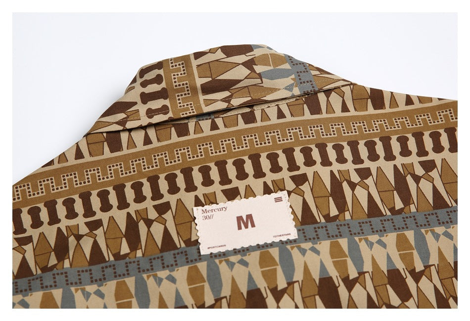 Close-up of the shirt collar and attached size tag against its brown geometric print.