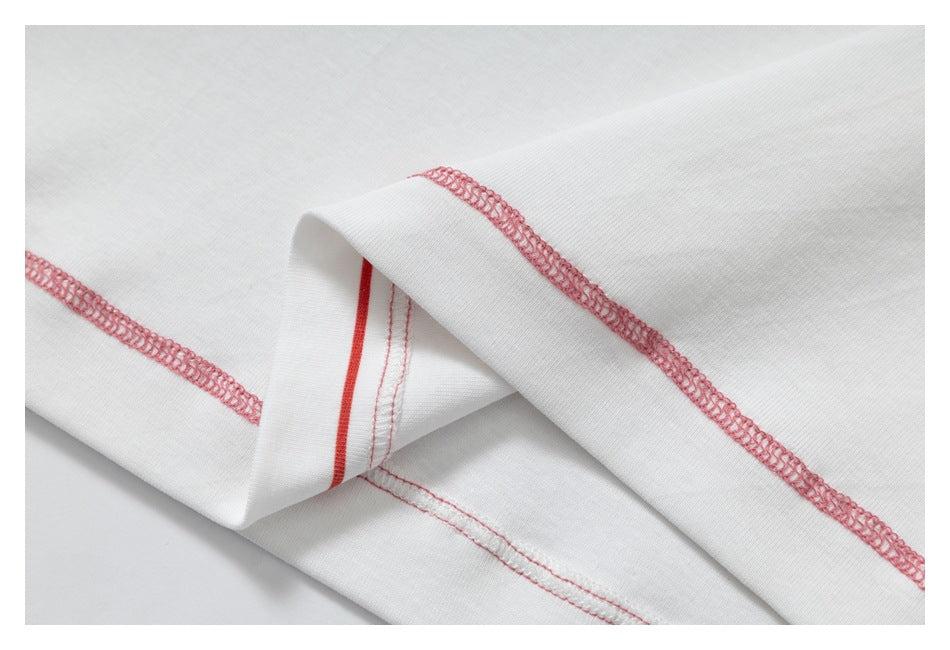 Folded white fabric showing pink overlock stitching and a narrow red seam line.