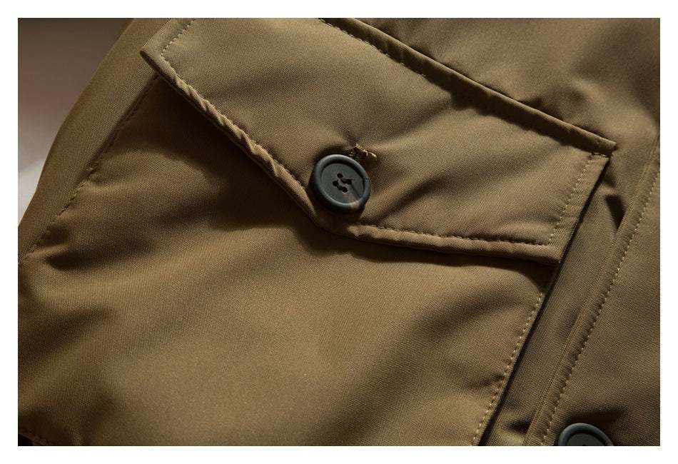 Close-up of a tan-brown flap pocket with a dark button and visible stitching.