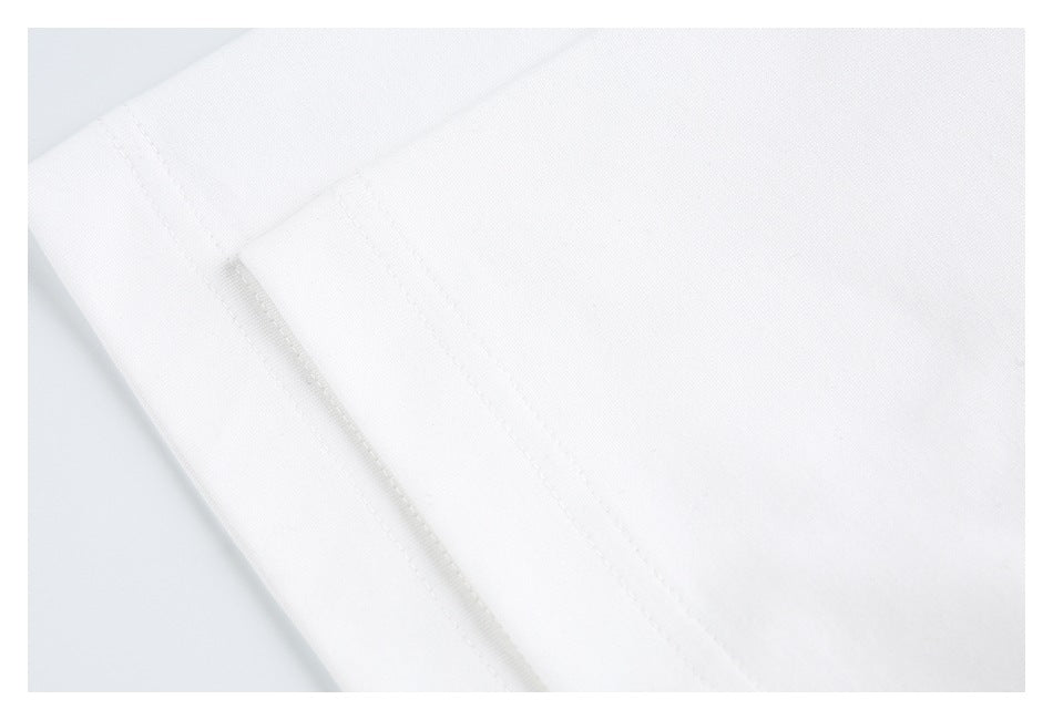 Close-up of white fabric with a stitched seam and folded edge.