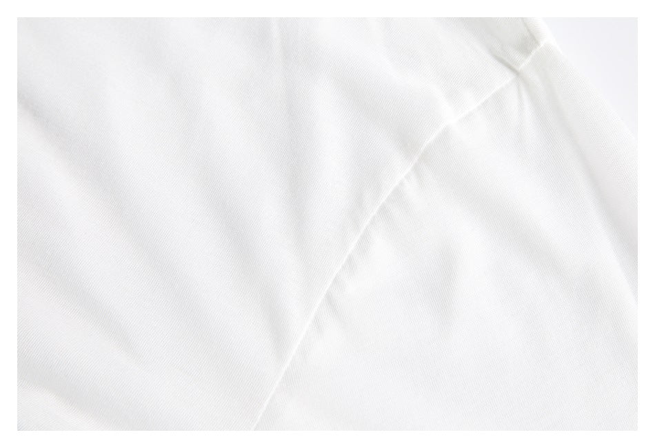 Close-up of a diagonal stitched seam on the white shirt fabric.