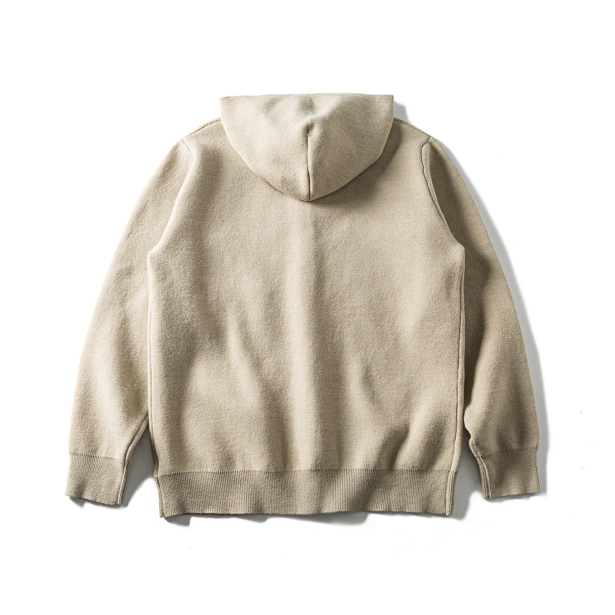 Back view of a beige hooded knit cardigan laid flat, with long sleeves and ribbed cuffs and hem.