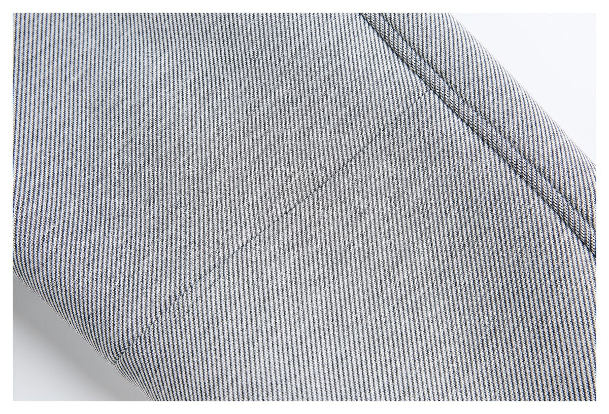 Close-up of finely striped black-and-white fabric with curved seam stitching.