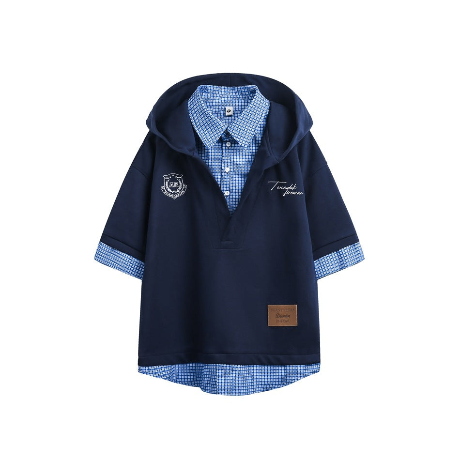Navy short-sleeve hooded top with blue check shirt layer, white crest print and brown patch, flat front view