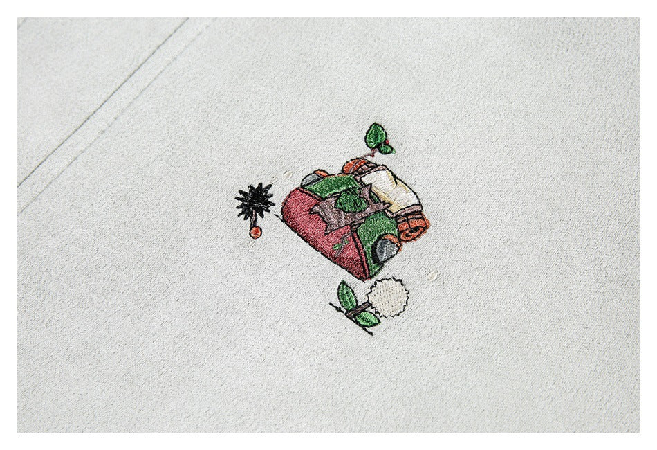 Small colorful embroidered illustration on the off-white coat fabric.