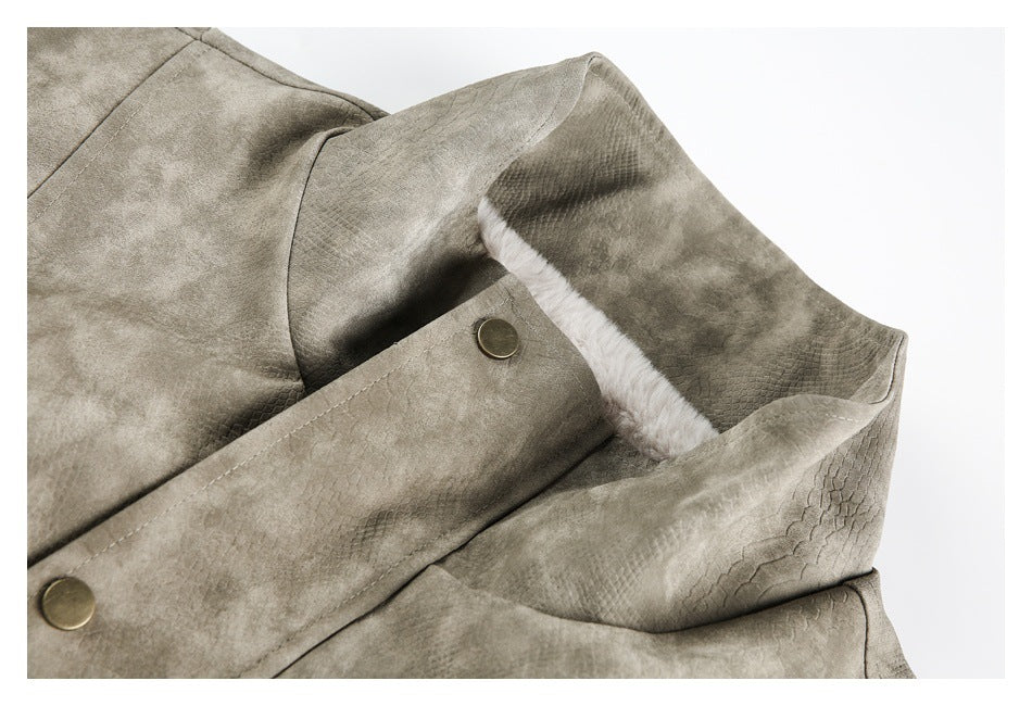 Close-up of a taupe jacket collar with white fluffy lining and a brass-tone snap button.