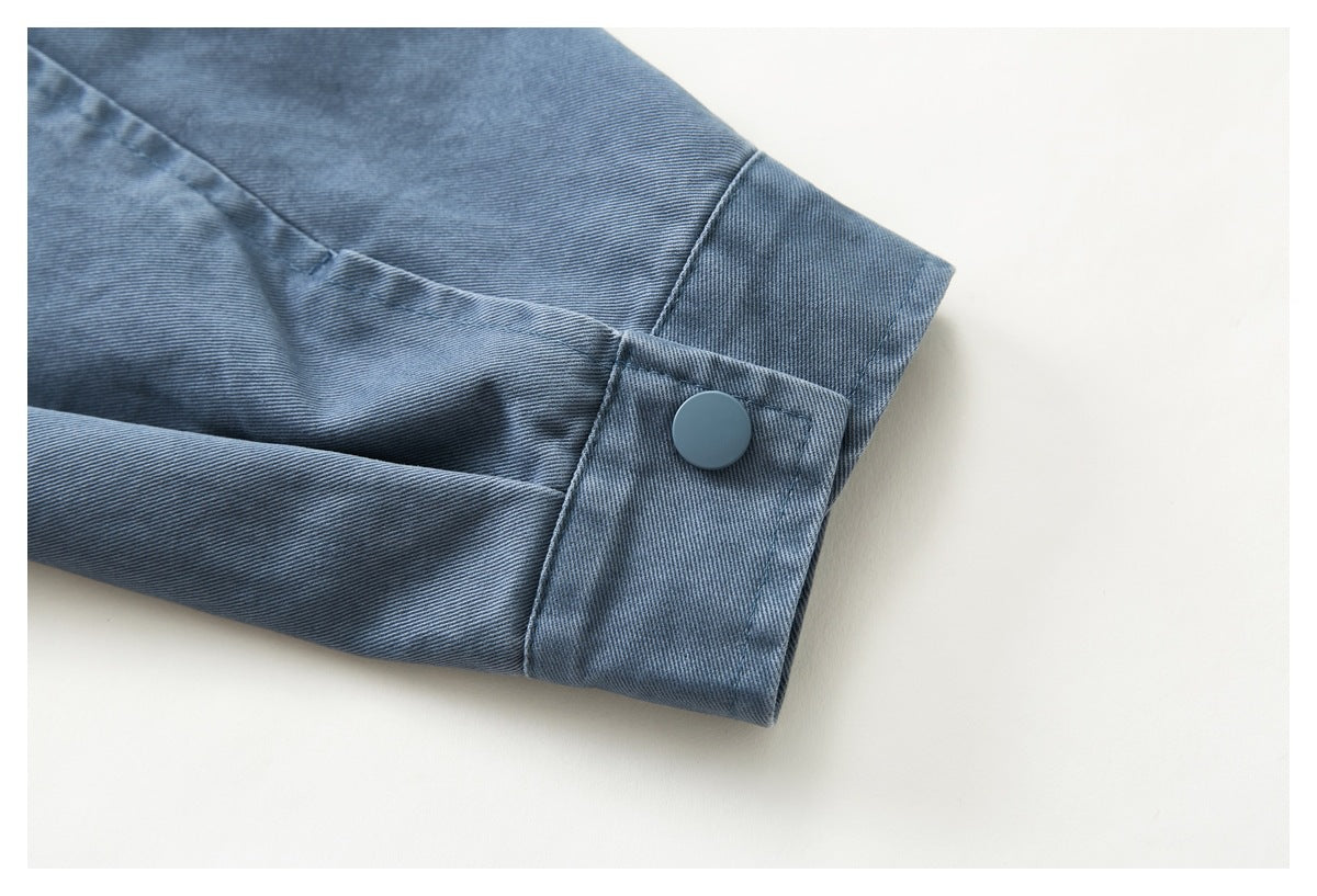 Close-up of a blue sleeve cuff with a matching round button.