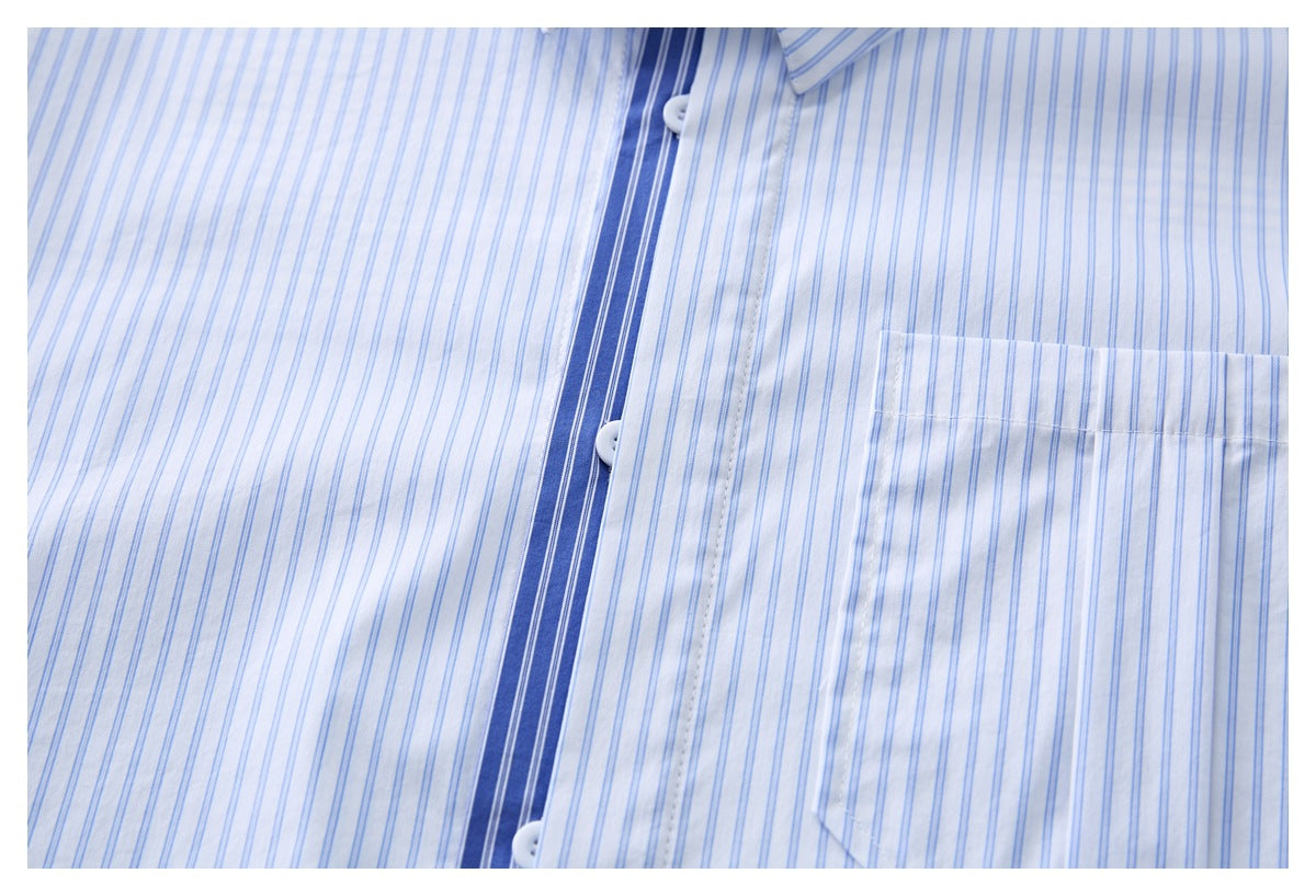 Close-up of the shirt's dark blue striped placket, white buttons, and chest pocket on fine blue stripes.