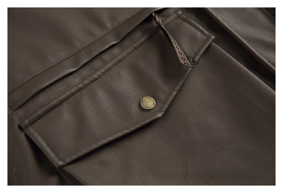 Close-up of a dark brown jacket pocket flap, brass-tone button, and patterned zipper pull.