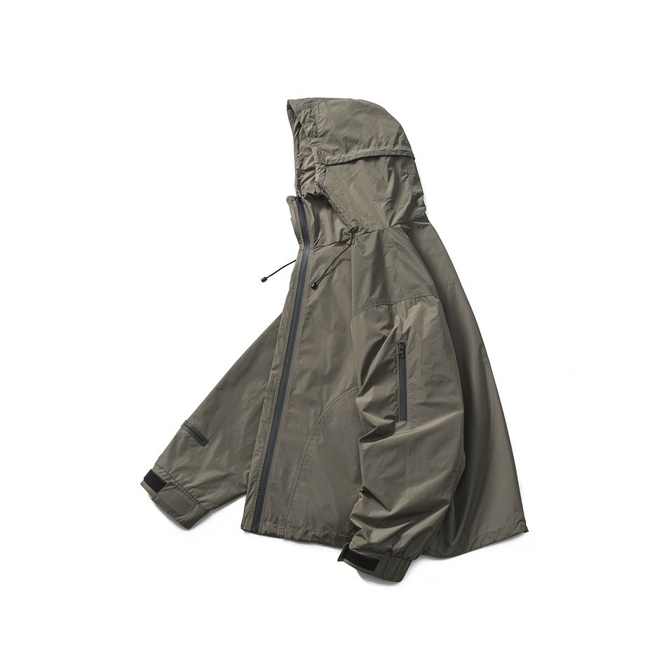 Olive gray hooded zip jacket laid on its side showing hood, front zipper, sleeve pocket and hook-and-loop cuff tabs