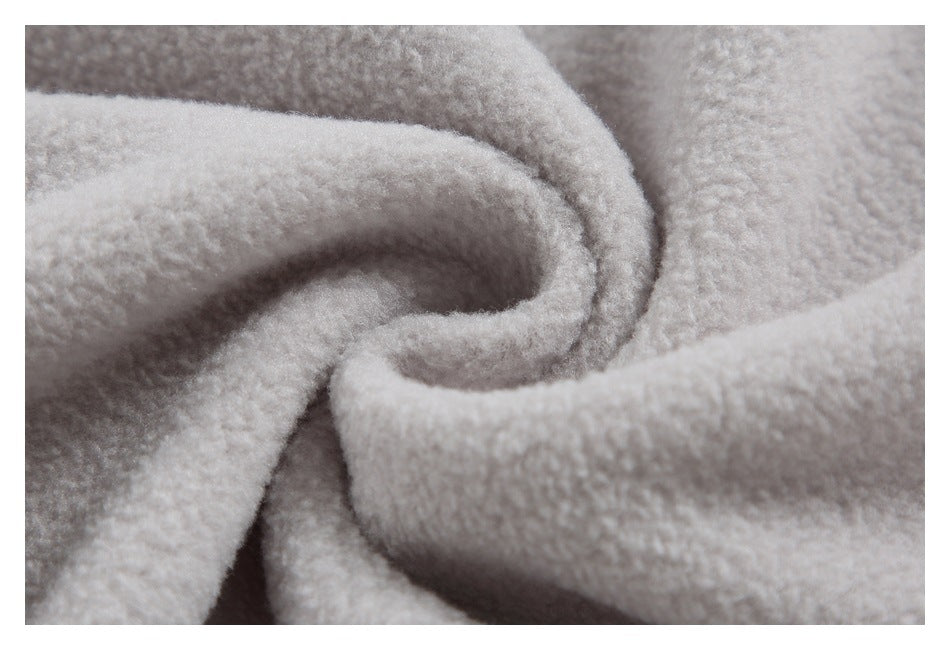 Extreme close-up of pale gray fuzzy fabric gathered into soft folds.