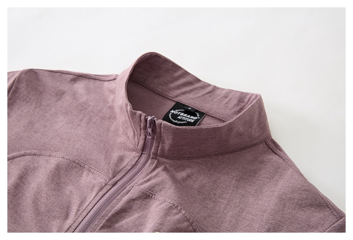 Close-up of the mauve top's stand collar, short zipper, and black sewn-in neck label.