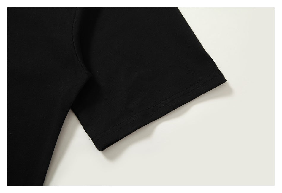 Close-up of a black short sleeve and its double-stitched hem.
