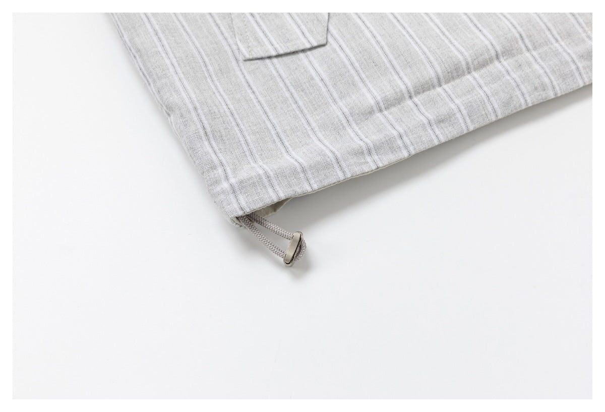 Close-up of the jacket's striped hem and adjustable drawcord with a metal toggle.