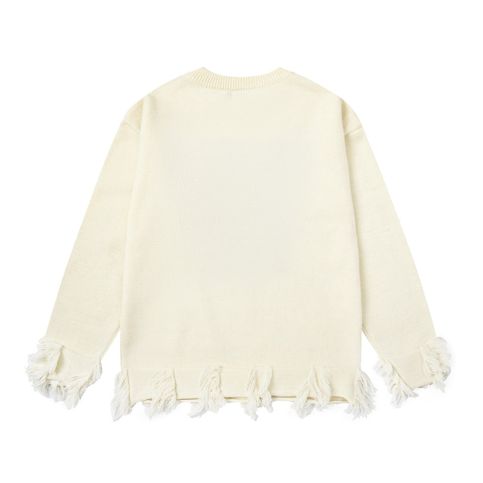 Flat view of the back of a cream crewneck sweater with fringe along the cuffs and hem.