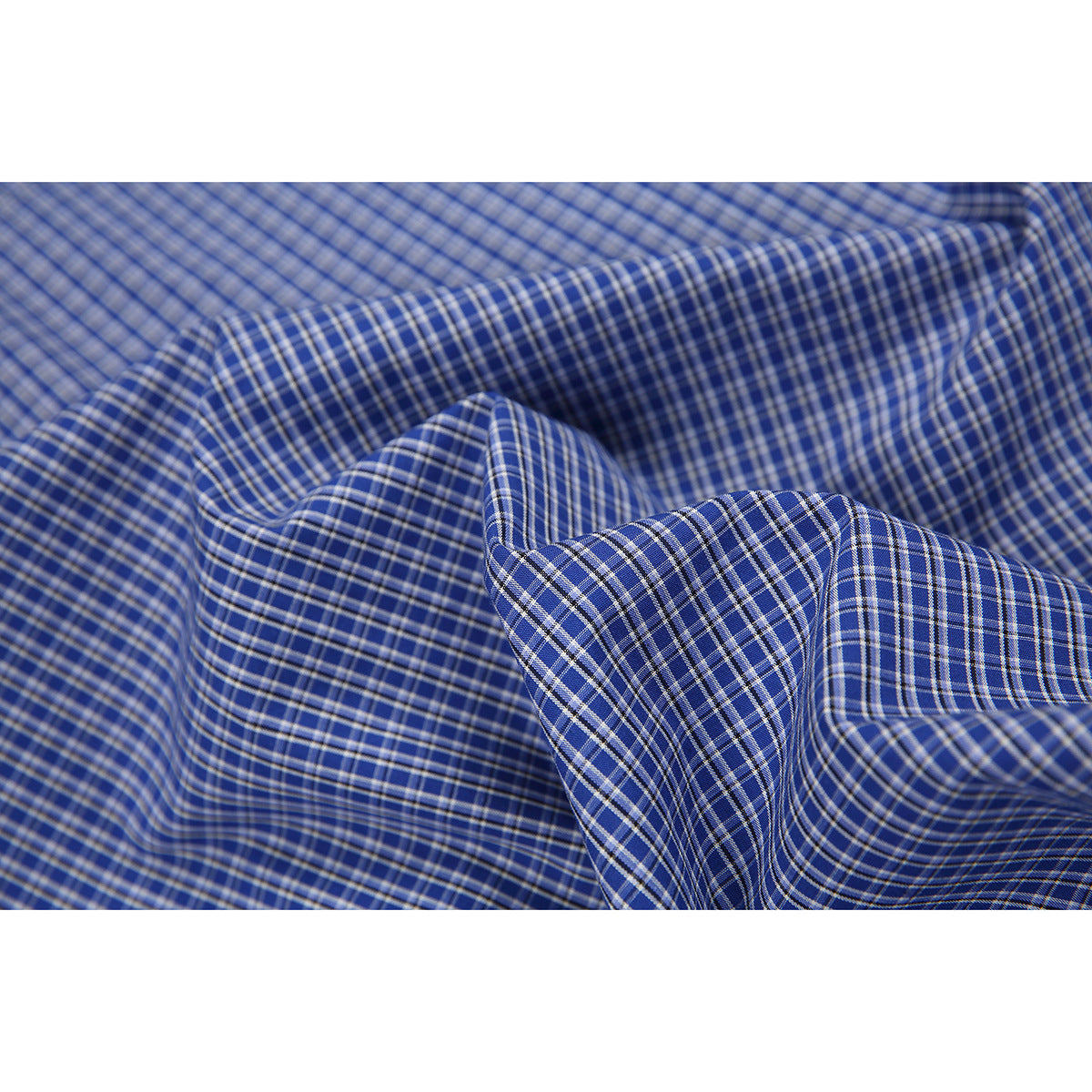 Close-up of blue checked shirt fabric gathered into folds.